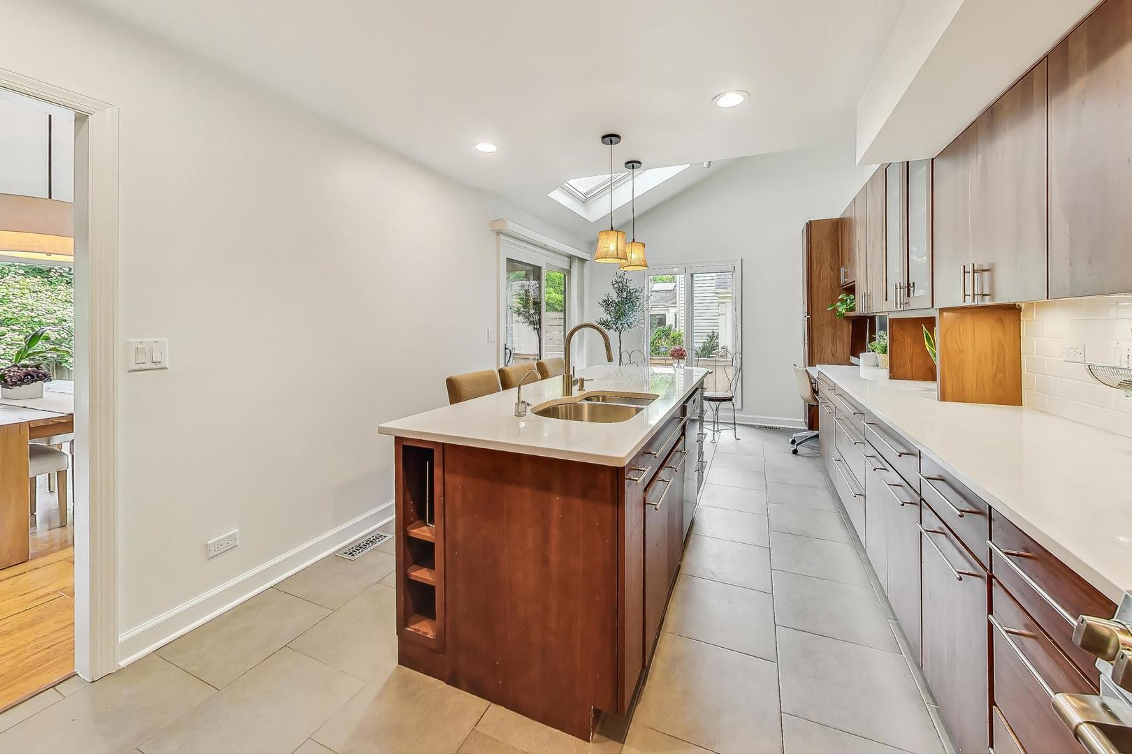 1169 Brighton Road Naperville, IL 60563 - Photo 13 of 54 a large kitchen with kitchen island a sink stainless steel appliances and cabinets