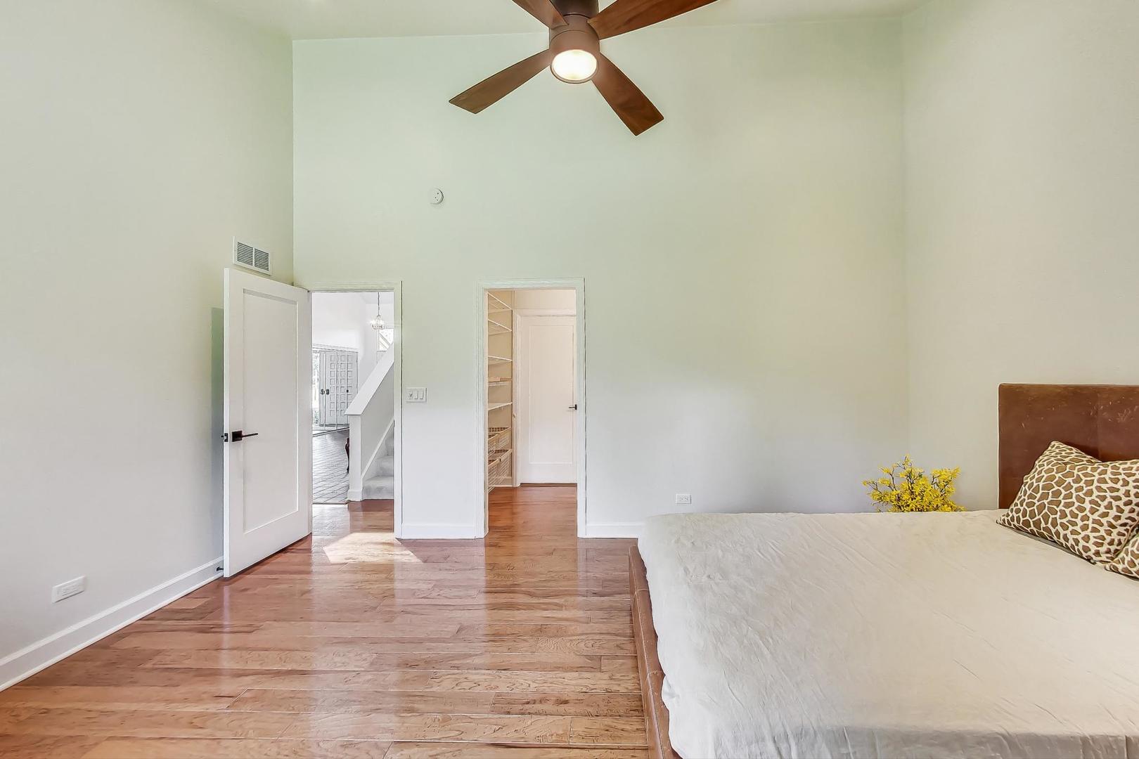 1169 Brighton Road Naperville, IL 60563 - Photo 18 of 54 a view of a bedroom with wooden floor and ceiling fan