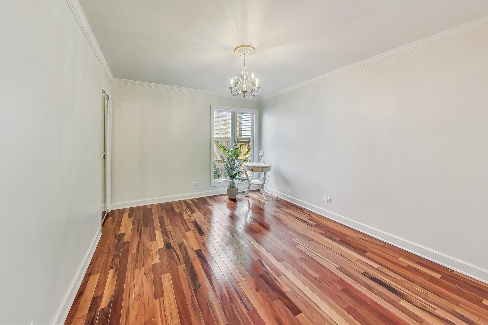 1169 Brighton Road Naperville, IL 60563 - Photo 23 of 54 a view of empty room with wooden floor and fan