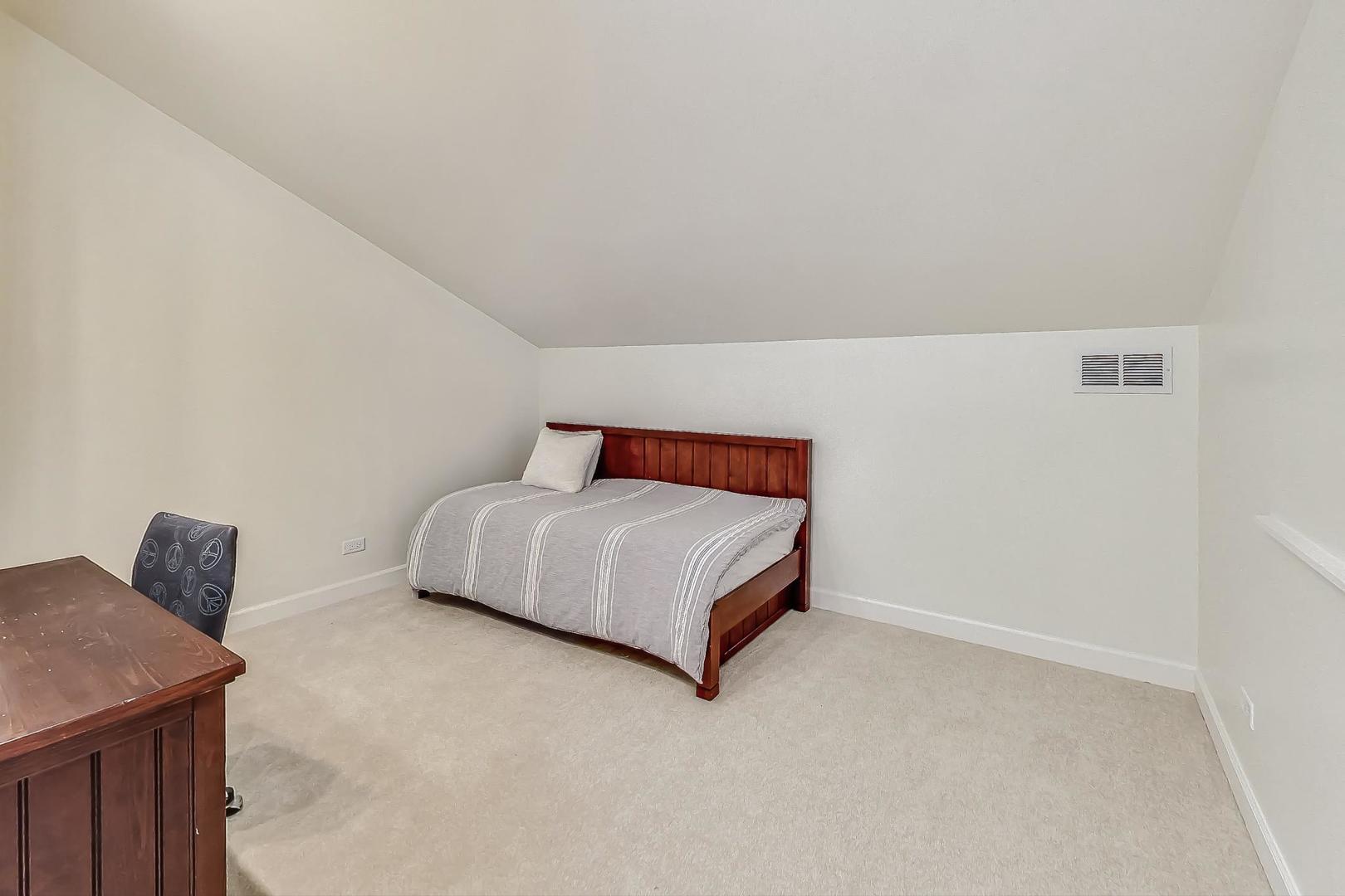 1169 Brighton Road Naperville, IL 60563 - Photo 34 of 54 a bedroom with a bed and a window