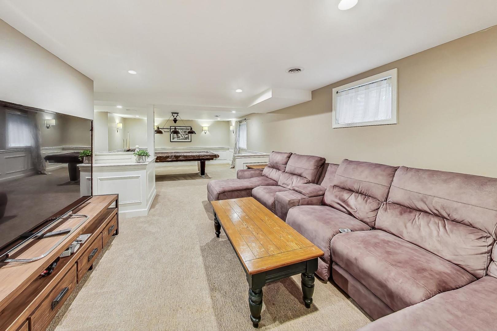 1169 Brighton Road Naperville, IL 60563 - Photo 36 of 54 a living room with furniture and a flat screen tv