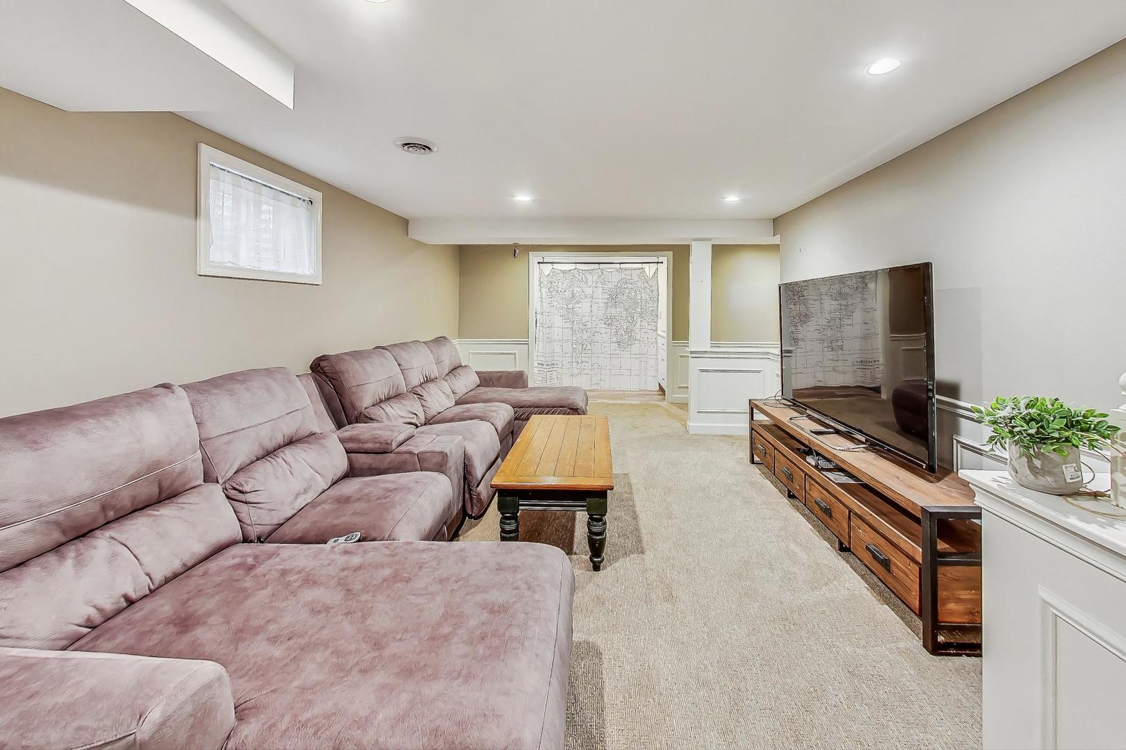 1169 Brighton Road Naperville, IL 60563 - Photo 37 of 54 a living room with furniture and a flat screen tv
