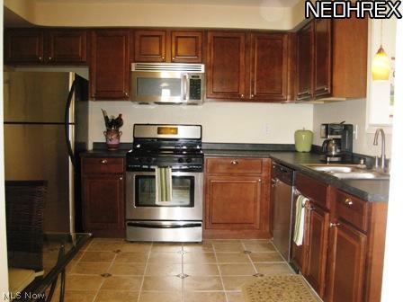 4238 Colony Road South Euclid, OH 44121 - Photo 7 of 24 Large/Spacious eat-in kitchen with newer cabinets, designer tile floors and stainless steel appliances