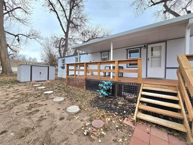 a house that has a tree in front of the house