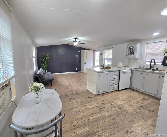 a kitchen with stainless steel appliances kitchen island wooden cabinets and granite counter tops