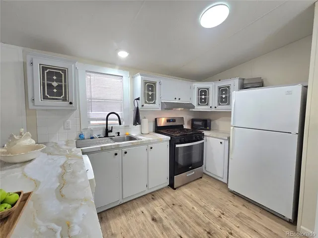 a kitchen with kitchen island granite countertop wooden cabinets and chairs