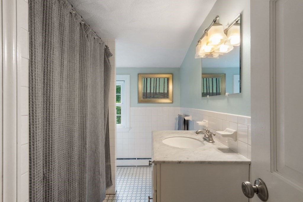 20 Chatham Circle Wellesley, MA 02481 - Photo 23 of 30 a bathroom with a sink and mirror