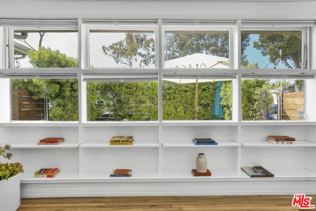 a view of a white house and a large window with the outer view