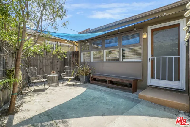 a backyard of a house with outdoor seating