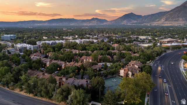 6852 Countrywoods Circle, Unit 5D Midvale, UT 84047 - Photo 47 of 50 Aerial perspective showcasing a residential community with mature trees and a tennis court