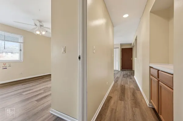 a view of a hallway with wooden floor and staircase