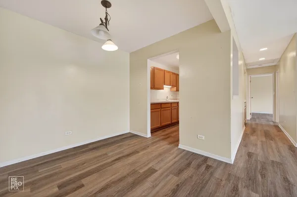 a view of a room with wooden floor and staircase