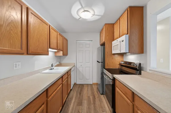 a kitchen with a sink stove and cabinets