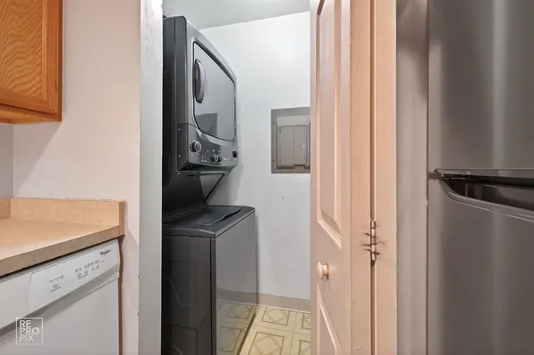 a kitchen with a refrigerator and a stove top oven