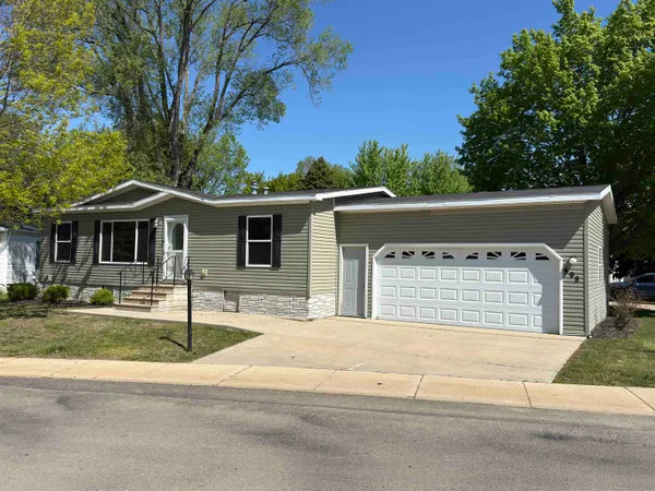a front view of a house with a garden and yard