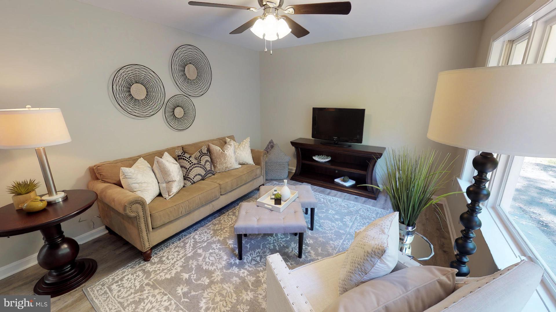 13284 Joy Road Lusby, MD 20657 - Photo 10 of 29 a living room with furniture and a flat screen tv