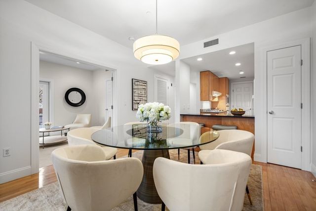 a living room with furniture kitchen and a chandelier