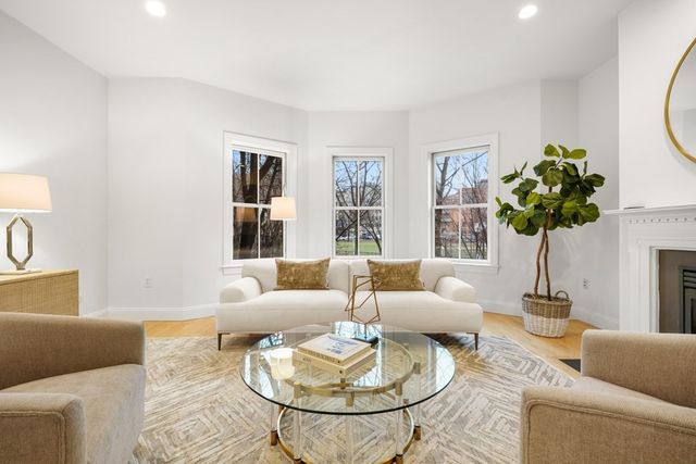 a living room with furniture and a potted plant