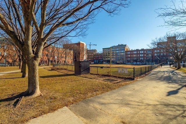 a view of a building with cars parked