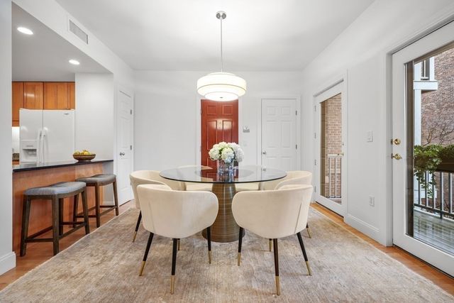 a view of a dining room with furniture and chandelier