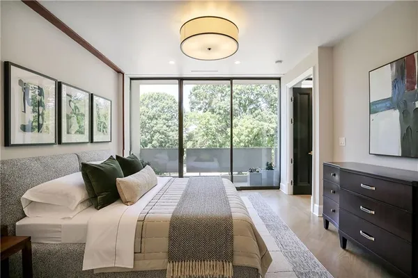 a bedroom with a bed and a large window