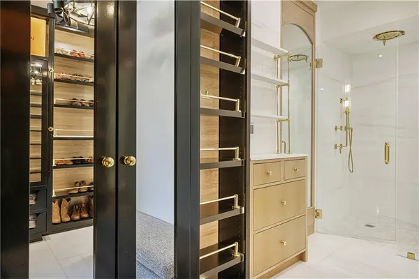 a view of walk in closet and bathroom