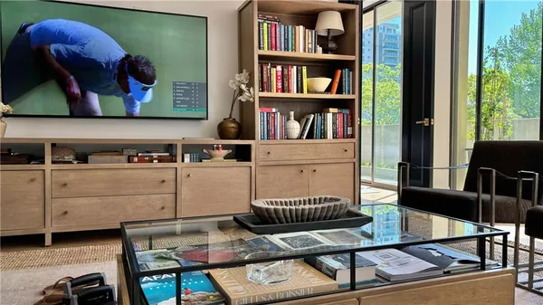 a living room with furniture and book shelf