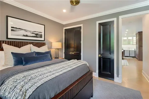 a bedroom with a bed and a chandelier