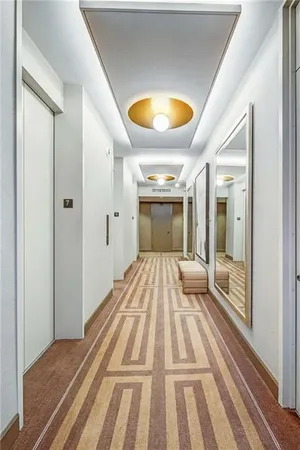 a view of a bedroom with wooden floor and a window