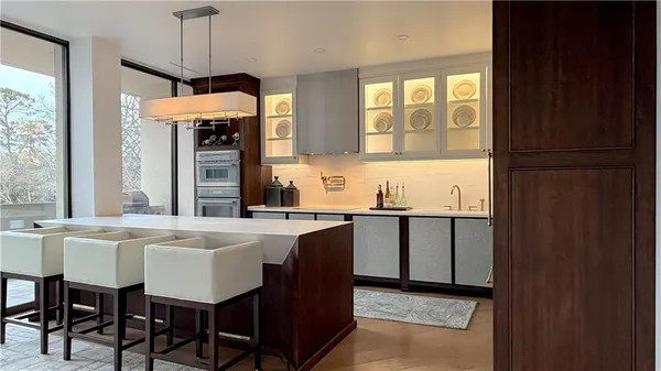 a kitchen with a sink a center island cabinets and appliances