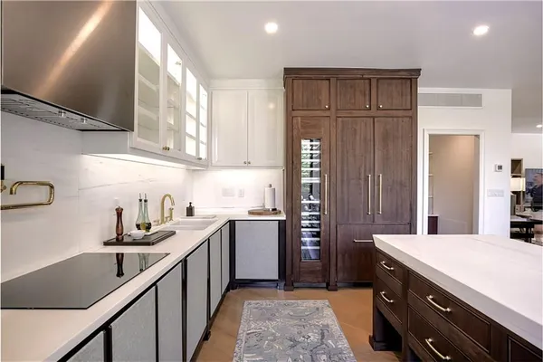 a kitchen with a sink stove and refrigerator
