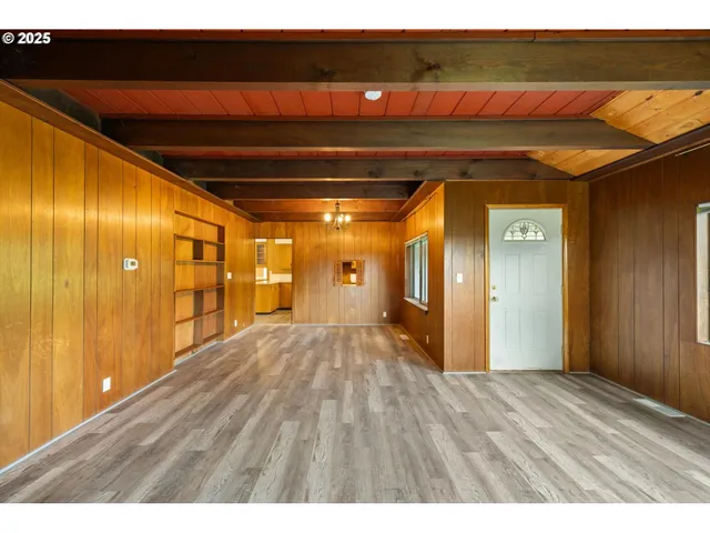 a kitchen with stainless steel appliances granite countertop wooden cabinets a stove a sink a island with wooden floor and cabinets