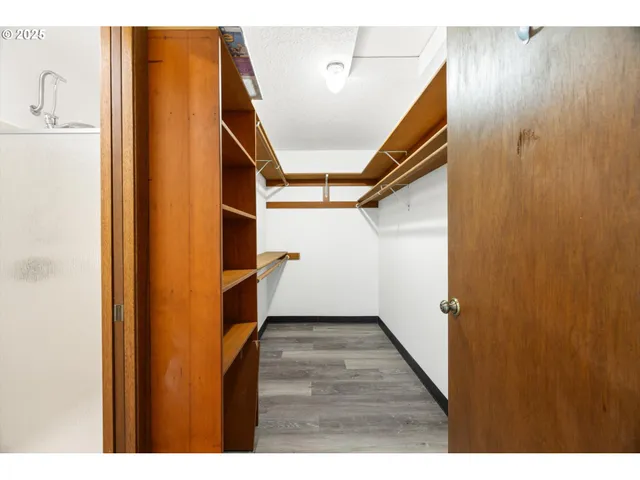 a view of an empty room and wooden floor