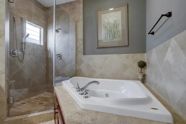 a bathroom with a tub and shower