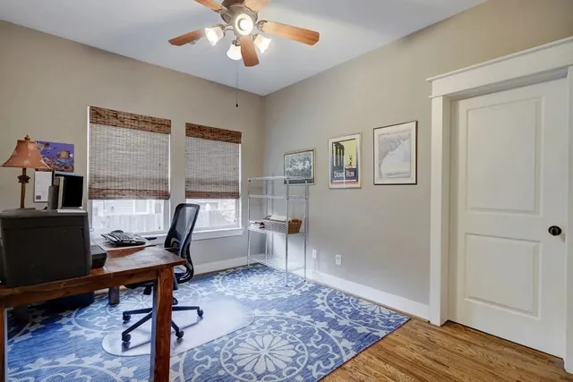 a view of a workspace with furniture and a window