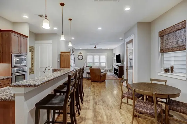 a large kitchen with a table and chairs