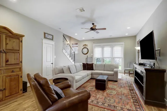 a living room with furniture fireplace and a flat screen tv