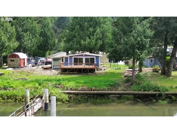 a view of a house with a yard and sitting area