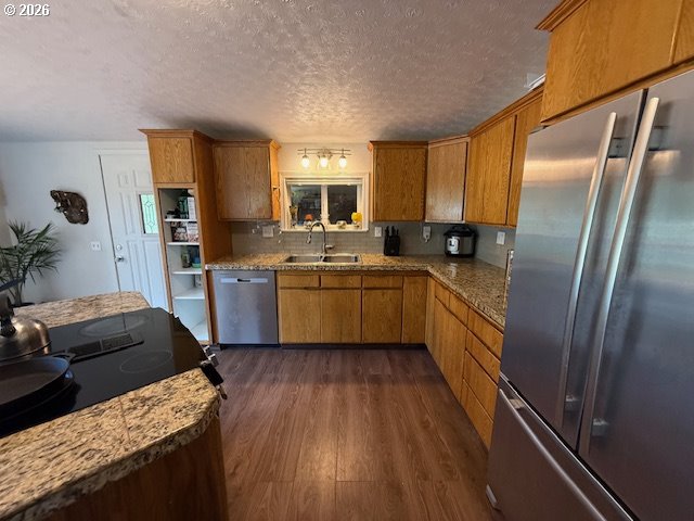 8429 Duncan Island Road Mapleton, OR 97453 - Photo 12 of 24 a kitchen with stainless steel appliances granite countertop a sink a stove and refrigerator