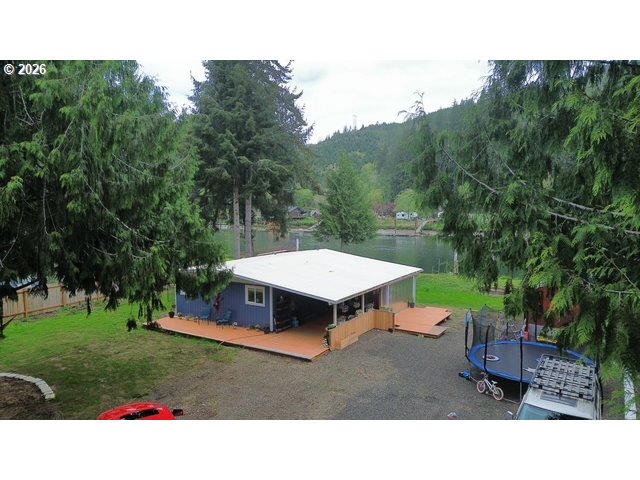 8429 Duncan Island Road Mapleton, OR 97453 - Photo 23 of 24 a backyard of a house with table and chairs