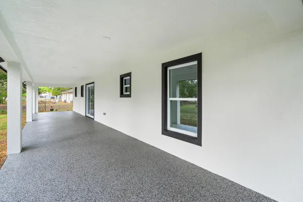 a view of house with garden space and trees