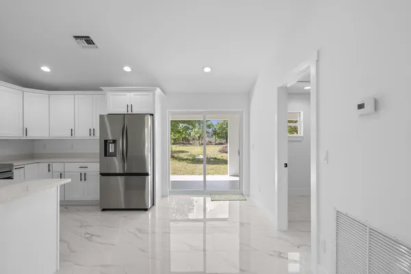a kitchen with stainless steel appliances a refrigerator and microwave