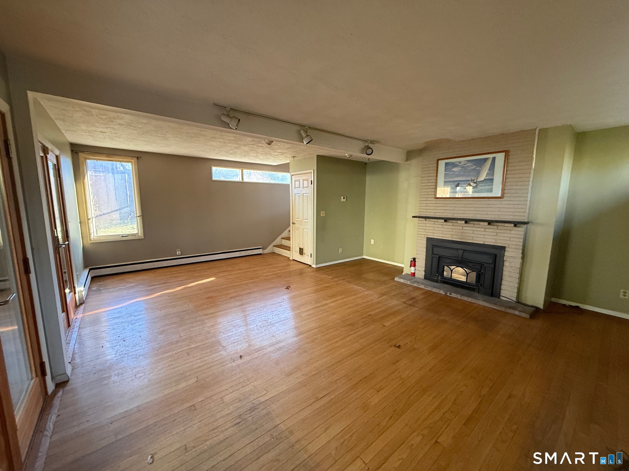 491 Shepard Avenue Hamden, CT 06514 - Photo 13 of 18 a view of an empty room with wooden floor and a fireplace