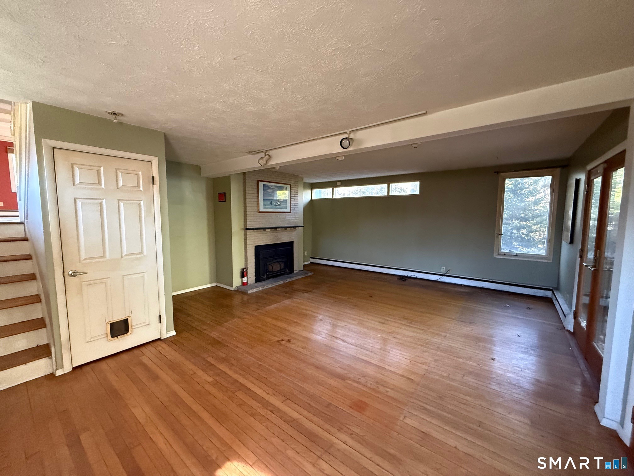 491 Shepard Avenue Hamden, CT 06514 - Photo 14 of 18 a view of empty room with wooden floor and fireplace