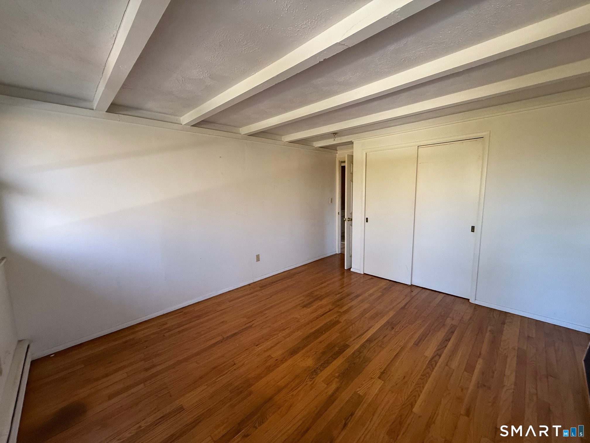 491 Shepard Avenue Hamden, CT 06514 - Photo 9 of 18 a view of an empty room with wooden floor