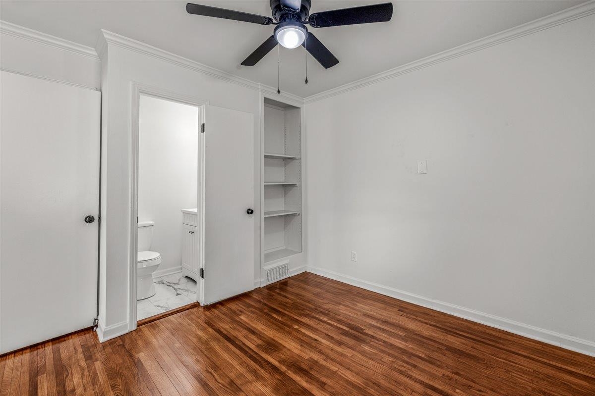 1244 Wells Station Road Memphis, TN 38122 - Photo 28 of 36 Unfurnished bedroom with ornamental molding, dark wood-type flooring, a ceiling fan, and ensuite bathroom