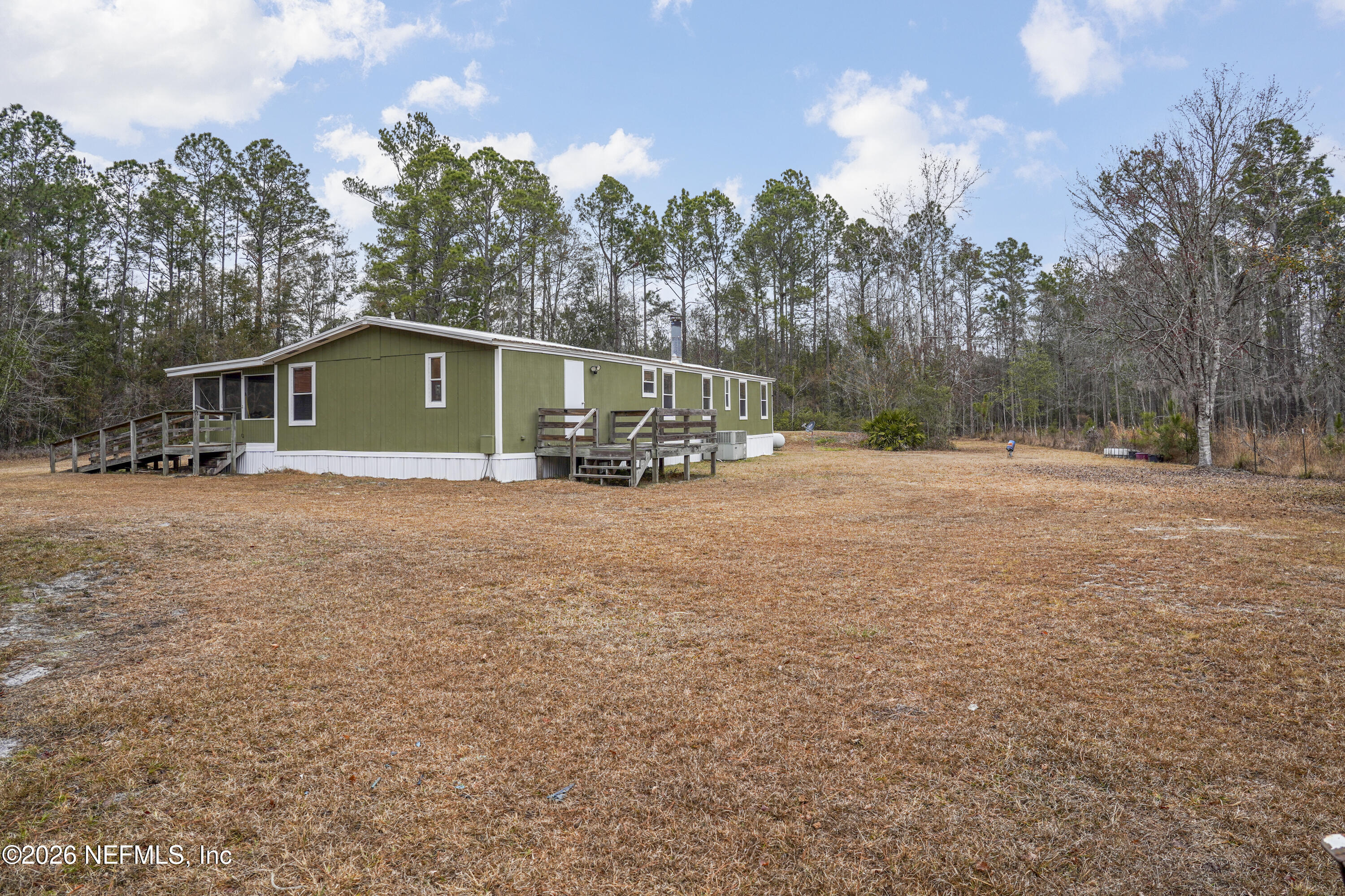 10697 County Road 127 Sanderson, FL 32087 - Photo 11 of 40 a front view of a house with a yard and trees