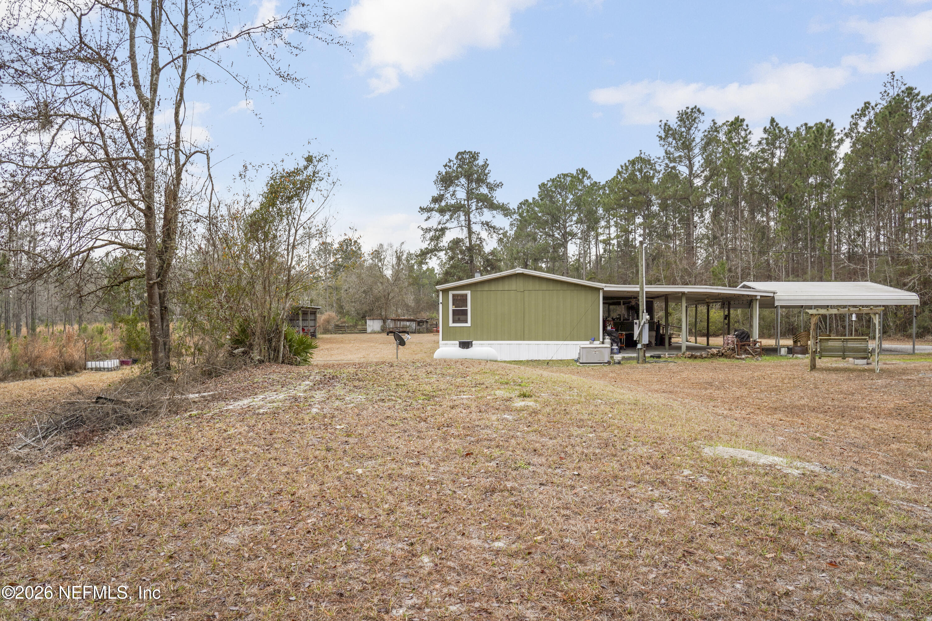 10697 County Road 127 Sanderson, FL 32087 - Photo 14 of 40 a house with trees in the background
