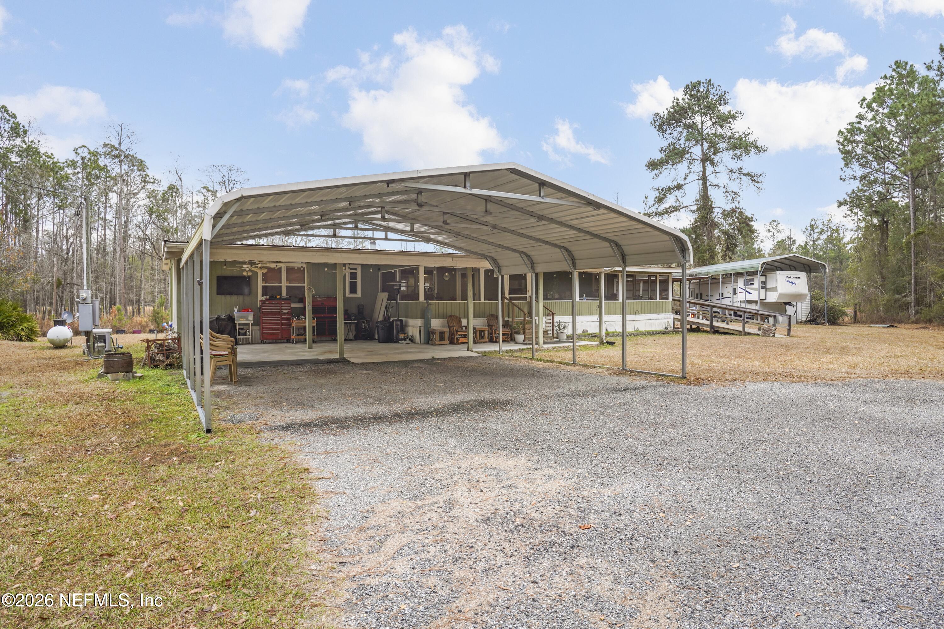 10697 County Road 127 Sanderson, FL 32087 - Photo 15 of 40 a view of a large building next to a yard with large trees