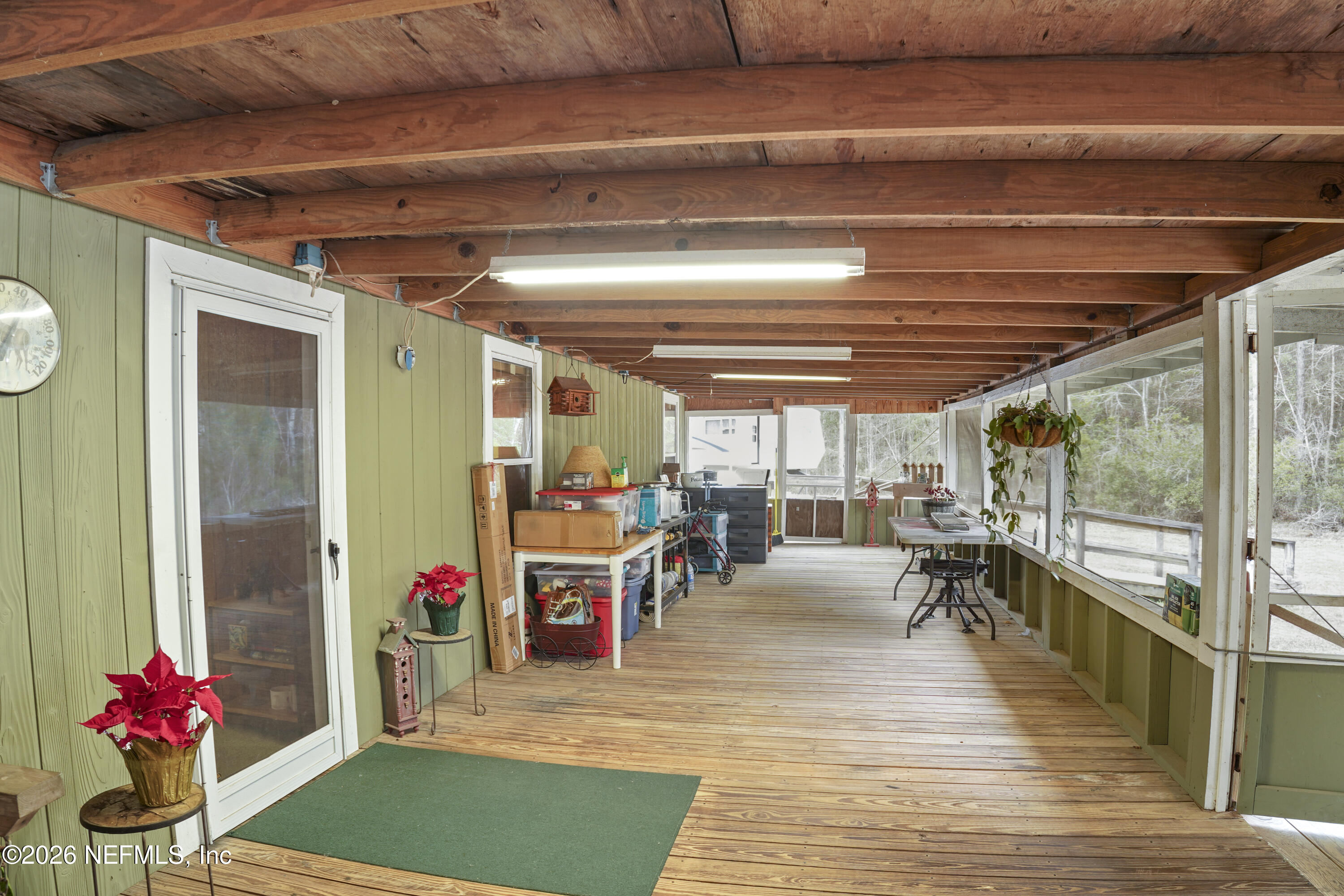 10697 County Road 127 Sanderson, FL 32087 - Photo 18 of 40 a view of a patio with table and chairs potted plants with wooden floor